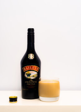 2021: Baileys Liquor Open Bottle With Filled Glass Standing On The White