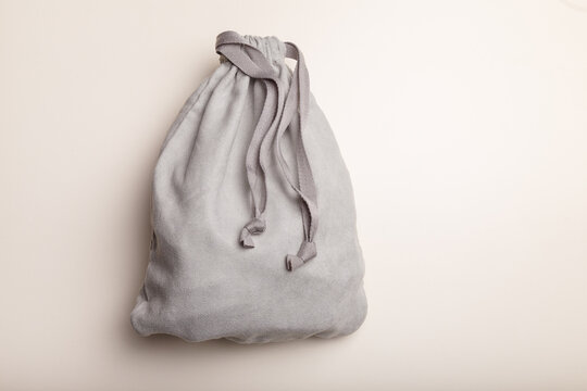 Grey fleece sack with tape on white background. Full tied container for small things, present concept. Top view, copy space.