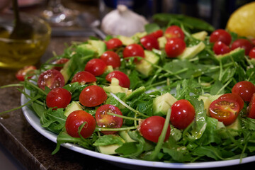 arugula salad and cherry tomatoes and avocado