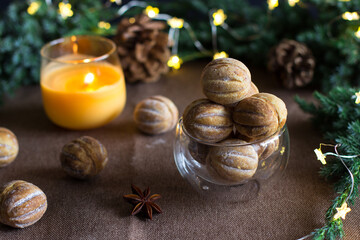 Nuts with condensed milk on a brown background against a background of fir branches