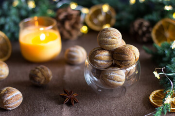 Nuts with condensed milk on a brown background against a background of fir branches