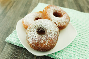 Round donuts on a square and white plate