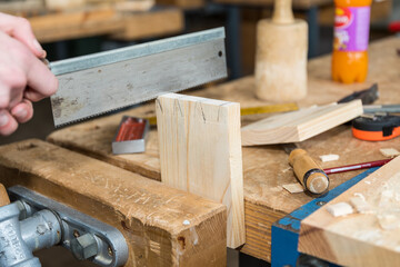 Handwerker mit Holzsäge in Werkstatt