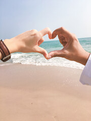 Hands in shape of love heart on the sea, love heart concept - 410225253