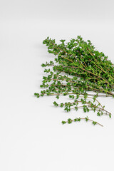 A bunch of fresh thyme on a white background. Vertical photo