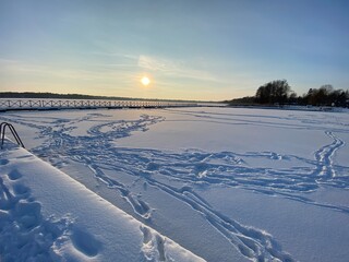 View of the frozen Białe Lake near Włodawa with wooden decks a lot of snow just before sunset golden hour © Józef