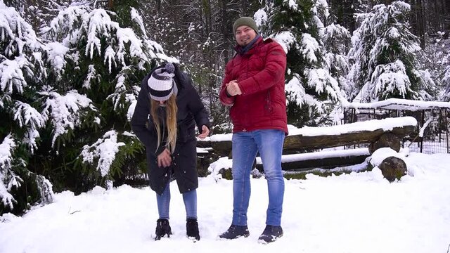 Couple having fun in winter forest