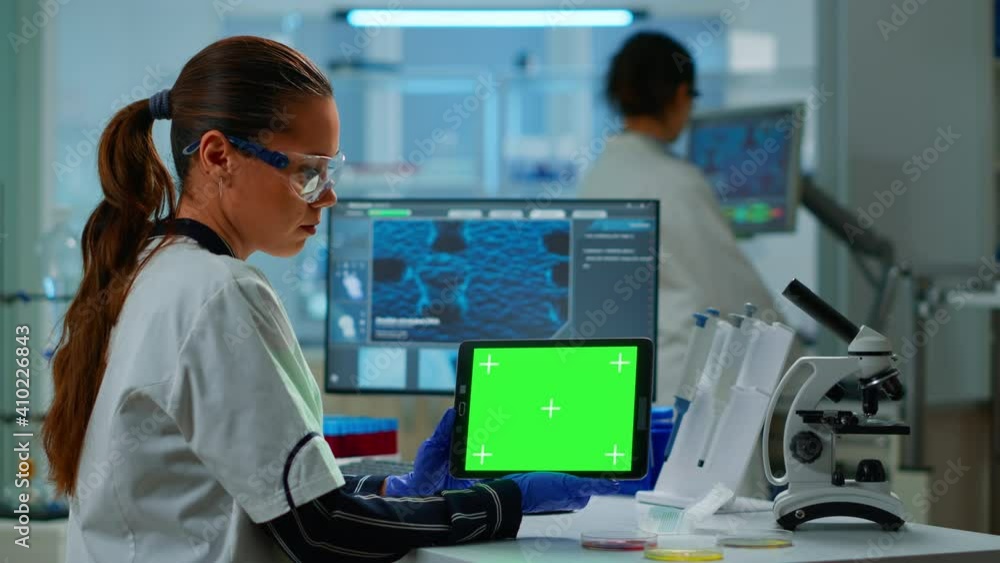 Poster medical research scientist working on tablet with green screen mock up template in applied science l