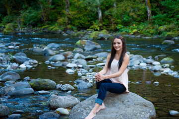 Young Woman Poses Along the Banks of a River