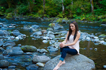 Young Woman Poses Along the Banks of a River