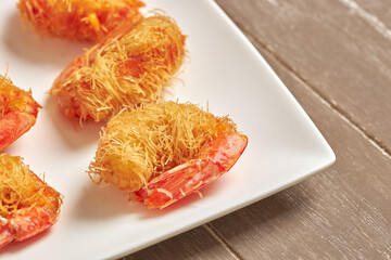 Close-up of kataifi-style breaded prawns.