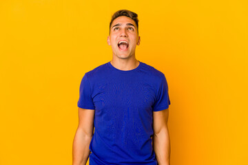 Young handsome caucasian man isolated shouting very angry, rage concept, frustrated.