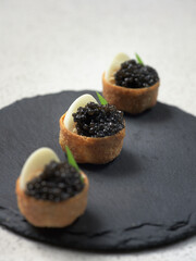 tartalett with black caviar plate