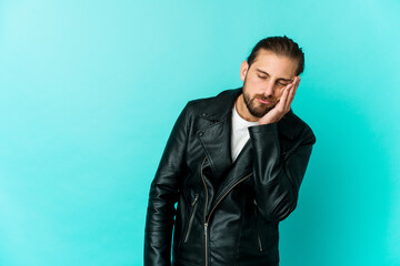 Young man with long hair look who feels sad and pensive, looking at copy space.