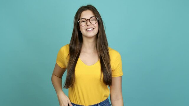 Teenager Brazilian girl with glasses smiling over isolated background