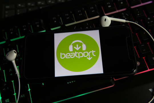 Viersen, Germany - January 9. 2021: Closeup of smartphone screen with logo lettering online electronic dance music streaming download service beatport on computer keyboard