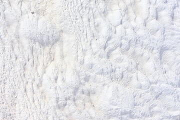 White natural surface of travertine, selective focus. Texture of carbonate mineral limestone in Pamukkale, Turkey. 