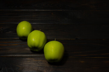 green apples on a wooden table