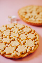 Delicious fragrant pies on a pink background.