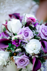 Purple and white roses and flowers in a bouquet