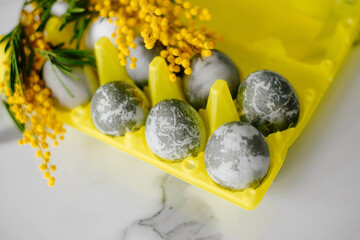 Happy Easter. Marble Eggs Mimosa on the Kitchen Table. Design and traditional decoration for the Holiday.