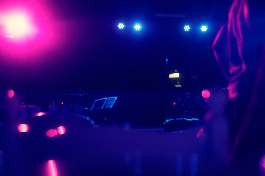 An empty music stage with pink and blue lights (vaporwave neon vibes). Getting ready for the show.