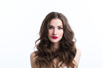 Fototapeta premium Indoor portrait of beautiful brunette young woman on white background.