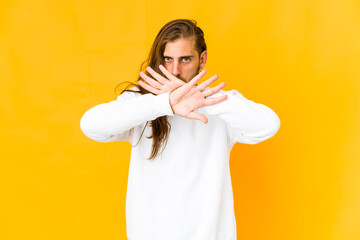 Young man with long hair look doing a denial gesture