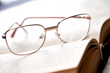 glasses on the book pages