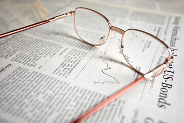 eyeglasses on the newspaper pages