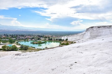 Fototapeta premium The surroundings of the famous Pamukkale travertines with beautiful tropical plants and swimming pool. Cotton castle in Turkey, Denizli Province.