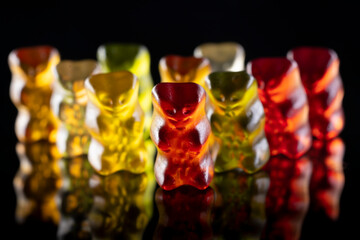 Sweet gummy bears on black background