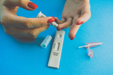 puncture of the finger with a lancet. quick blood test. test strip for the diagnosis of...