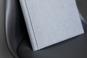 family photo book. stylish Photo album on chair . grey photobook with  leather cover. Beautiful...
