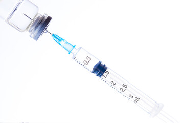 Hand holds syringe with needle in vial. Treatment and hospital concept
