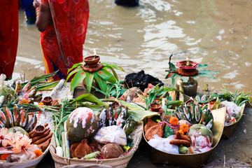 holy offerings of fruits flowers lamps and cloths in river to sun god on the occasion of chhath puja or chatt puja