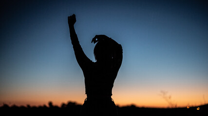 silhouette of a woman at sunset