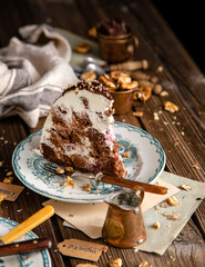 slice of half shpere shaped chocolate cake with white cream, glaze and nuts on top