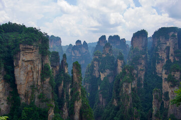 Fototapeta na wymiar Zhangjiajie Cliff Mountains - National Forest Park Landscape in China. Dark Avatar Mountains. Mysterious and gloomy cliffs. 