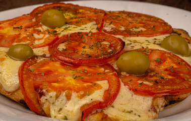 Home made Napolitana italian Pizza with cheese and tomate sauce. 