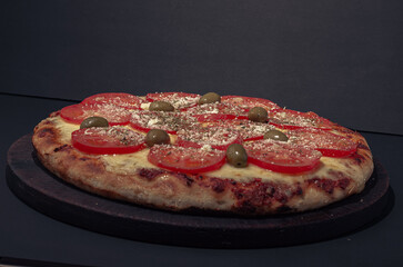 Home made Napolitana italian Pizza with cheese and tomate sauce. 