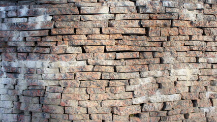 stone wall made of marble bricks. texture of walls of marble bricks. marble brick wall pattern. stone fence 