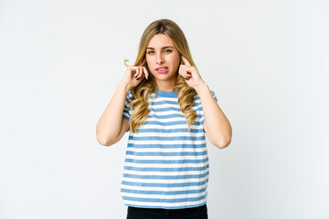 Fototapeta premium Young caucasian blonde woman covering ears with fingers, stressed and desperate by a loudly ambient.