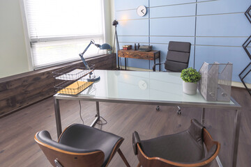 Modern trendy creative design of a personal studio office with a seating area in the style of minimalism in blue and beige colors with large windows and daylight