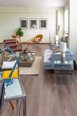 Modern trendy creative design of a personal studio office with a seating area in the style of minimalism in blue and beige colors with large windows and daylight