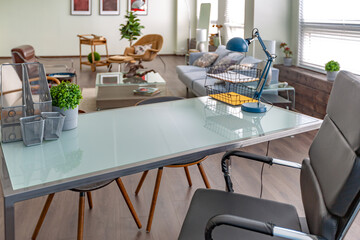 Modern trendy creative design of a personal studio office with a seating area in the style of minimalism in blue and beige colors with large windows and daylight