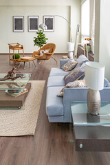 Modern trendy creative design of a personal studio office with a seating area in the style of minimalism in blue and beige colors with large windows and daylight