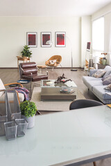 Modern trendy creative design of a personal studio office with a seating area in the style of minimalism in blue and beige colors with large windows and daylight
