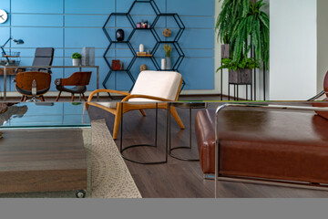 Modern trendy creative design of a personal studio office with a seating area in the style of minimalism in blue and beige colors with large windows and daylight