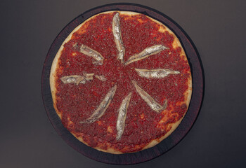 Home made anchovies italian Pizza tomate sauce. Black background.